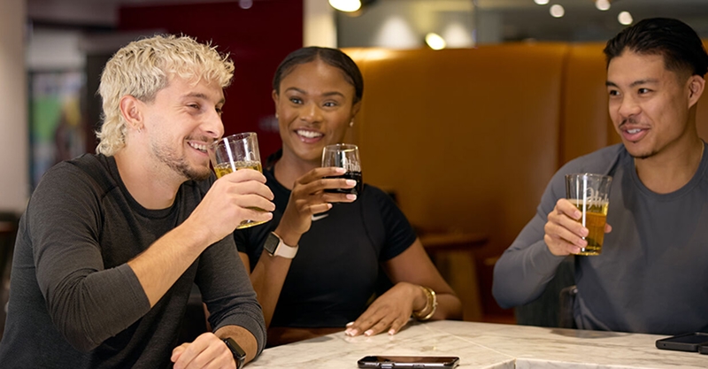 Three Adelaide Club members enjoying drinks together in the HUB lounge.